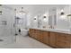 Spa-like bathroom with double vanities, a soaking tub, and a separate glass-enclosed shower at 2781 Stanfield Ave, Orlando, FL 32814
