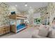 Whimsical bedroom with bunkbeds, a sofa, and a playful wallpaper design at 2781 Stanfield Ave, Orlando, FL 32814