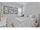 Modern bedroom with minimalist decor, white bedding, and stylish abstract art at 2781 Stanfield Ave, Orlando, FL 32814
