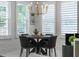 Bright dining area featuring a round table set for four, with white shutters and a decorative chandelier at 2781 Stanfield Ave, Orlando, FL 32814