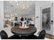 Dining area featuring a round table set for four, with views of the kitchen and living room at 2781 Stanfield Ave, Orlando, FL 32814
