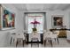 Dining room with modern chandelier, glass table, and white chairs in a well-lit space at 2781 Stanfield Ave, Orlando, FL 32814