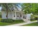 Charming home with a covered front porch, white columns, manicured landscaping, and mature trees at 2781 Stanfield Ave, Orlando, FL 32814