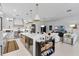 Bright kitchen with modern white cabinets, stainless steel appliances, and a large island with a built-in wine fridge at 2781 Stanfield Ave, Orlando, FL 32814
