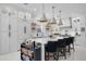 Spacious kitchen featuring a large island, bar stools, white cabinetry, and modern lighting at 2781 Stanfield Ave, Orlando, FL 32814