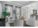 Bright living room with white walls, marble floors, stylish chairs, and elegant decor at 2781 Stanfield Ave, Orlando, FL 32814