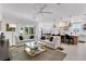 Open concept living space with plush sofas, a glass coffee table, and a view into the kitchen at 2781 Stanfield Ave, Orlando, FL 32814