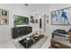 Bright living room with modern decor, stylish furniture, and large screen TV at 2781 Stanfield Ave, Orlando, FL 32814
