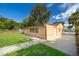 View of the home's backyard with lush green grass and mature trees at 2918 E Central Blvd, Orlando, FL 32803