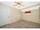 Carpeted bedroom featuring a ceiling fan, a door to outside, and natural light from a window at 2918 E Central Blvd, Orlando, FL 32803