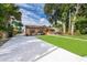 Charming single-story home featuring a well-manicured lawn and a long driveway at 2918 E Central Blvd, Orlando, FL 32803