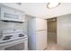 Bright white kitchen with refrigerator, microwave, stove and tiled floors at 2918 E Central Blvd, Orlando, FL 32803