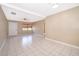 Cozy living room with tiled flooring, a white door, and a ceiling fan at 2918 E Central Blvd, Orlando, FL 32803