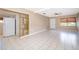 Bright and airy living room featuring tiled flooring and a white front door at 2918 E Central Blvd, Orlando, FL 32803