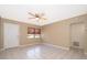 Comfortable living room featuring tiled flooring, a ceiling fan, and a white door at 2918 E Central Blvd, Orlando, FL 32803