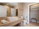 Modern bathroom featuring a sleek vanity, walk-in closet, and tiled accents at 3056 Rockefeller Way, Kissimmee, FL 34747