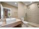 Modern bathroom with a vanity, toilet, and a shower with tiled walls, exuding elegance at 3056 Rockefeller Way, Kissimmee, FL 34747