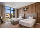 Comfortable twin bedroom with industrial design elements, large window and natural light at 3056 Rockefeller Way, Kissimmee, FL 34747
