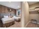Comfortable bedroom with two beds, decorative wall clock, and closet, perfect for relaxation at 3056 Rockefeller Way, Kissimmee, FL 34747