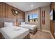 Charming bedroom featuring two beds, a decorative clock, skis decor, and window views at 3056 Rockefeller Way, Kissimmee, FL 34747