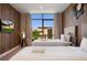 Stylish bedroom featuring two beds, wood-paneled accent wall, and a large window providing ample natural light at 3056 Rockefeller Way, Kissimmee, FL 34747