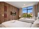 Cozy bedroom showcasing two beds, a TV, vintage skis wall decor, and a large window with views at 3056 Rockefeller Way, Kissimmee, FL 34747