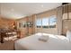 Comfortable bedroom includes a king bed, sitting area, and a media center with large windows at 3056 Rockefeller Way, Kissimmee, FL 34747