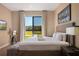 Well-lit bedroom with queen size bed, outside views, and a mounted TV at 3056 Rockefeller Way, Kissimmee, FL 34747