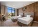 Cozy bedroom features two twin beds, a modern industrial theme, and a large window with views at 3056 Rockefeller Way, Kissimmee, FL 34747