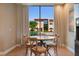 Bright dining space with a round table, comfortable seating, and a large window at 3056 Rockefeller Way, Kissimmee, FL 34747