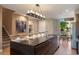 Modern kitchen boasts a large island, sleek countertops, and stylish lighting for a luxurious culinary space at 3056 Rockefeller Way, Kissimmee, FL 34747