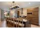 Modern kitchen with a large island, stylish bar stools, and stainless steel appliances at 3056 Rockefeller Way, Kissimmee, FL 34747