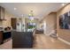 Open-concept kitchen with a large island, stainless steel appliances, and modern finishes at 3056 Rockefeller Way, Kissimmee, FL 34747