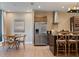Well-designed kitchen with a stainless steel refrigerator, modern cabinets, and a dining area at 3056 Rockefeller Way, Kissimmee, FL 34747