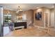 Open kitchen and dining area with a spacious island, modern lighting, and staircase at 3056 Rockefeller Way, Kissimmee, FL 34747