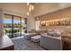 Stylish living room features comfortable furniture, wall art, and outdoor views through expansive sliding glass doors at 3056 Rockefeller Way, Kissimmee, FL 34747