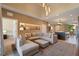 Open-concept living room with plush seating, stylish decor, and seamlessly connected to a modern kitchen at 3056 Rockefeller Way, Kissimmee, FL 34747