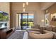 Spacious living room with plush seating, a modern TV setup, and access to an outdoor patio at 3056 Rockefeller Way, Kissimmee, FL 34747
