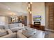 Expansive living room with a fireplace, a large TV, and an open layout connecting the kitchen and dining areas at 3056 Rockefeller Way, Kissimmee, FL 34747