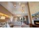 Bright and airy living space with a soaring ceiling, a modern fireplace, and seamless integration with the kitchen at 3056 Rockefeller Way, Kissimmee, FL 34747