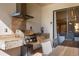 Outdoor kitchen with stainless steel grill, granite countertops, and adjacent dining table at 3056 Rockefeller Way, Kissimmee, FL 34747
