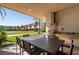 Outdoor dining area with a built-in grill, a spacious table, and a serene view of the community greenery at 3056 Rockefeller Way, Kissimmee, FL 34747
