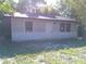 Modest single-story home featuring horizontal siding, trimmed windows and door and a dark roof at 31429 Anna St, Deland, FL 32720