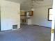 Spacious living area with kitchen view featuring ceiling fan, tiled floor, and neutral wall paint at 31429 Anna St, Deland, FL 32720