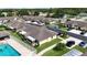 Inviting aerial view of a beautiful residential community with a sparkling pool and well-manicured lawns at 3280 Villa Way Cir, St Cloud, FL 34769