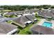 Aerial view of a residential area with a pool and green spaces between the homes and parking at 3280 Villa Way Cir, St Cloud, FL 34769