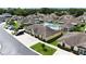 Community aerial view showcasing the pool and various homes with ample parking spaces and landscaping at 3280 Villa Way Cir, St Cloud, FL 34769
