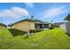 Well-maintained backyard featuring lush green grass, trimmed hedges, and the building's exterior at 3280 Villa Way Cir, St Cloud, FL 34769