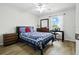 Comfortable bedroom with ample natural light and hardwood floors and stylish furniture at 3280 Villa Way Cir, St Cloud, FL 34769