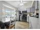 Functional kitchen with modern appliances, white cabinetry, and a cozy dining area at 3280 Villa Way Cir, St Cloud, FL 34769